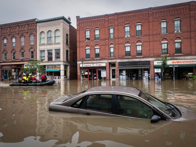 a car is stranded in a flooded street.